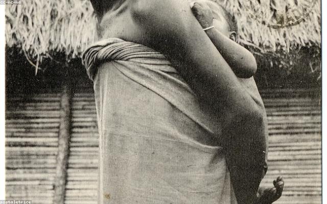A caregiver holding the hand of an orphaned child